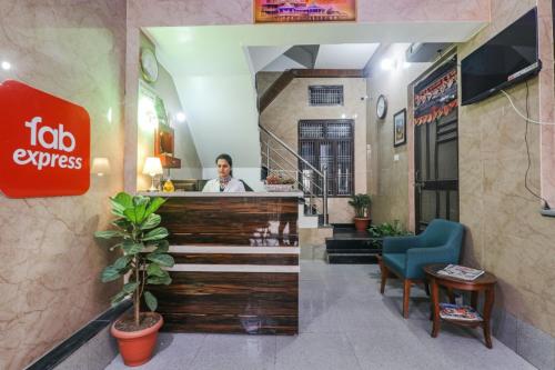 a man behind the counter of a restaurant at FabExpress Milan Palace in Ayodhya