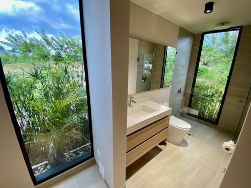 a bathroom with a sink and a large window at Casa MOARA in Pereira