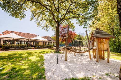 a playground in the yard of a house at Vakantiepark de Luttenberg in Luttenberg