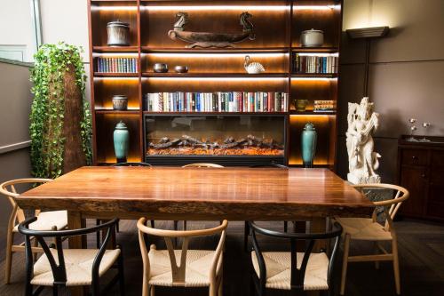 a dining room table with chairs and a fireplace at Pagoda Resort & Spa in Perth