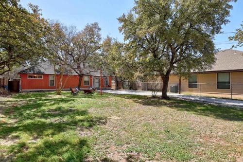 a yard with two trees and a building at Stunning Lake Travis Retreat in Austin in Buffalo Gap