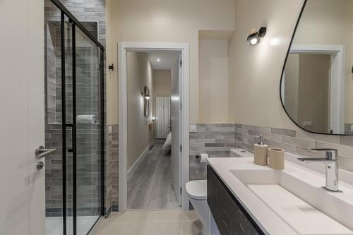 a bathroom with a sink and a mirror at Waou Glam Plaza España in Madrid