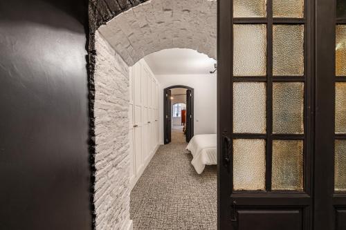 a hallway with a brick wall and a bedroom at Waou Plaza de España IV - Alquiler Corta Duración in Madrid