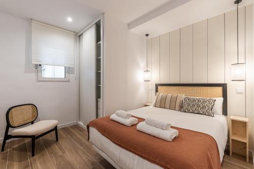a bedroom with a bed with two towels on it at Waou Best IV Madrid Rio in Madrid