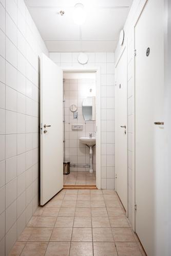 an empty bathroom with a sink and a toilet at Injoy Park Hotel Solna in Solna