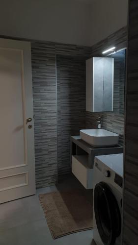 a bathroom with a sink and a toilet and a mirror at I Giardini Magenta in Magenta