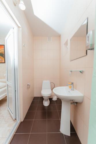 a bathroom with a toilet and a sink at Aura in Zatoka