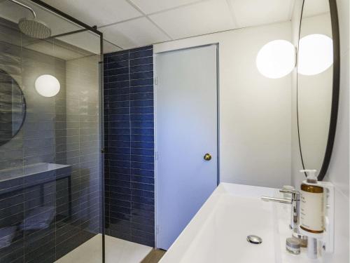 a bathroom with a shower and a white sink at Mercure Marseille Centre Bompard La Corniche in Marseille