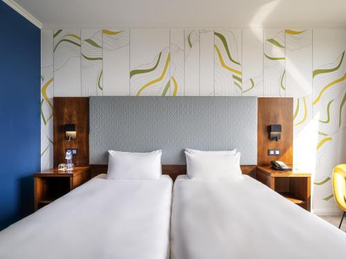 Кровать или кровати в номере Maek Hotel Antwerp Central - Handwritten Collection