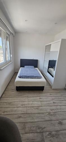 a bedroom with a bed and a mirror at Apartman BINGO Bugojno in Bugojno