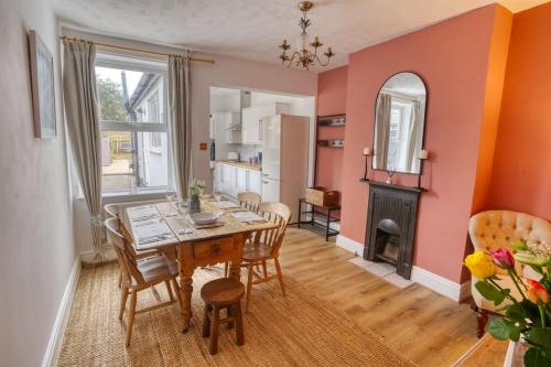 a dining room with a table and a fireplace at Charming 3-Bedroom Home Close to Attractions in Lincoln