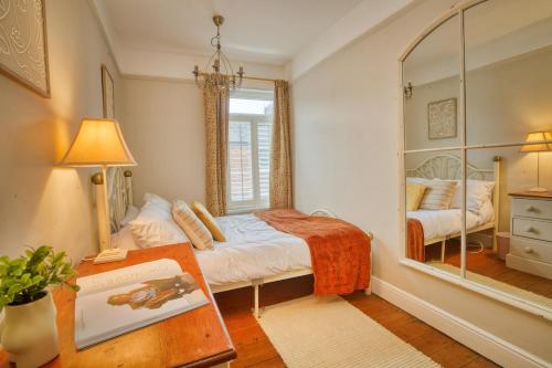 a small bedroom with a bed and a mirror at Charming 3-Bedroom Home Close to Attractions in Lincoln