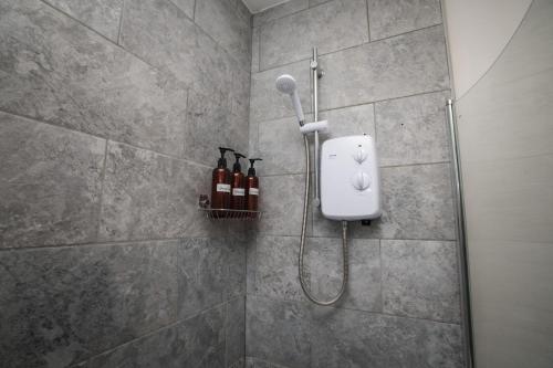 a shower with a blow dryer in a bathroom at Charming 3-Bedroom Home Close to Attractions in Lincoln