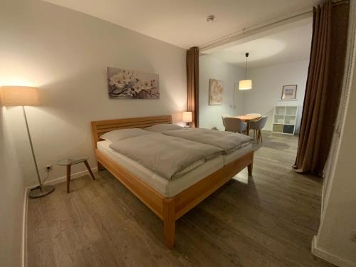 a bedroom with a bed and a table in it at Schönes Appartement in Neubrandenburg