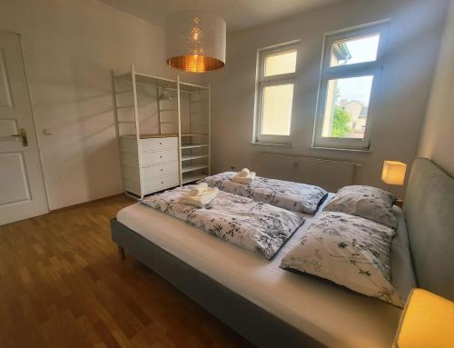 a bed with three pillows on it in a bedroom at Lottes Glück in Weimar