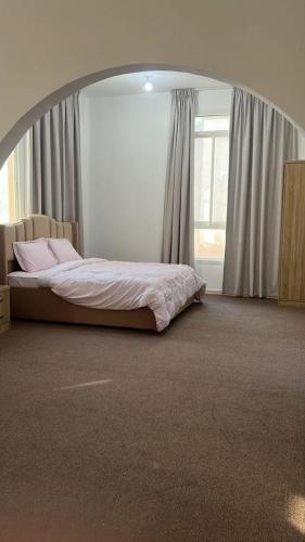 a bedroom with a bed in a circular room at Khalifa A Home Stay Suite Room in Abu Dhabi