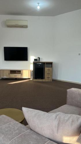 a living room with a flat screen tv and a couch at Khalifa A Apartement V15 in Abu Dhabi