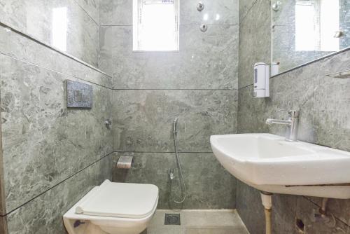 a bathroom with a sink and a toilet at HOTEL OXUS, Pratap Nagar in Jaipur