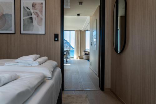 a hotel room with two beds and a mirror at Serene cabin in Lofoten with sauna in Kleppstad