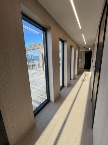 an empty hallway with a large window in a building at Serene cabin in Lofoten with sauna in Kleppstad