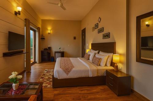a hotel room with a bed and a television at The Amber Signature Vrindavan # A Contemporary Luxury Hotel With #Lift# Parking# Ac Rooms# & Elegant interior # Near Prem Mandir in Vrindāvan