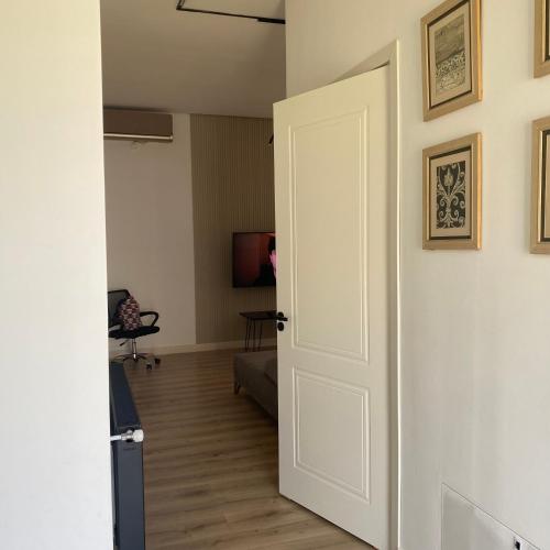 an open door to a living room with a couch at Teos sweet home in K'obulet'i