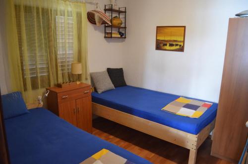 a small bedroom with two beds and a window at Holiday Home Bah in Kruševo