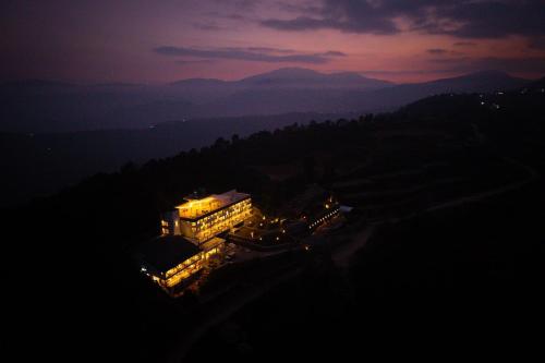 a building lit up at night with lights at Nana Mountain Resort Mt Annapurna View in Astam