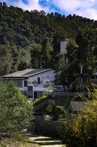 a white building in front of a mountain at Nana Mountain Resort Mt Annapurna View in Astam
