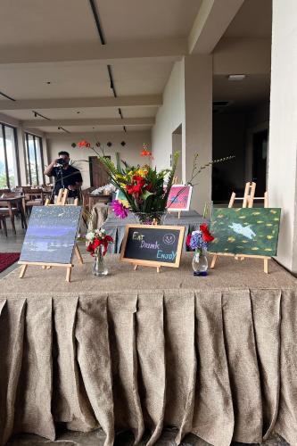 a table with a sign and flowers on it at Nana Mountain Resort Mt Annapurna View in Astam
