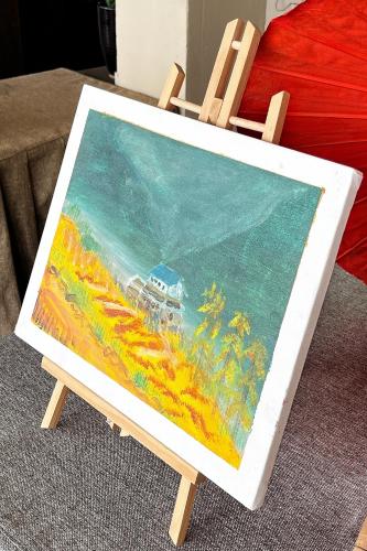 a painting of a train in a field on a chair at Nana Mountain Resort Mt Annapurna View in Astam