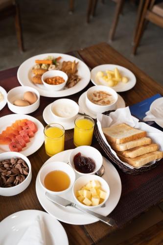 a wooden table with plates of food on it at Nana Mountain Resort Mt Annapurna View in Astam