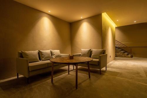 a living room with a couch and a table at Nana Mountain Resort Mt Annapurna View in Astam