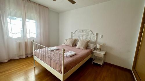 a bedroom with a bed in a room with a window at Amanecer zen in Argés