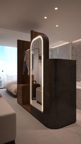 een spiegel in een slaapkamer met een bed en een stoel bij Harpazul in Catoira