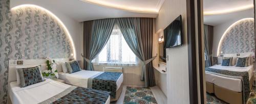 A bed or beds in a room at Dündar Hotel