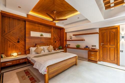 a bedroom with a bed and wooden walls and a ceiling at HSR Penthouse Spacious 4-BHK Apartment with Living, Lounge Area, Study Room, Terrace & Balconies in Bengaluru