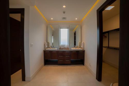 a bathroom with a sink and a large mirror at Montecielo 4A 3 bdrs ocean view in Los Suenos in Herradura