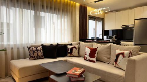 a living room with a couch with pillows on it at Luxury Hermes Apartement Marina View-Mall-Parking in Tangier