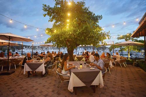 a group of people sitting at tables in a restaurant at Colina 7C 3 bdr Garden View in Los Suenos in Herradura