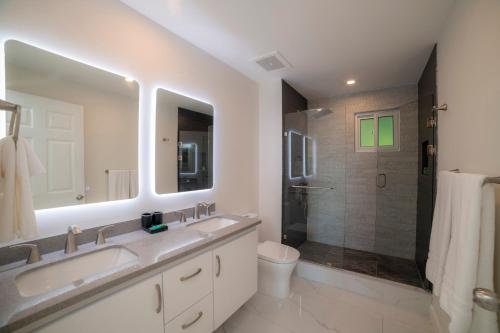 a white bathroom with a sink and a shower at Del Mar 1G 3 bdr Ocean View in Los Suenos in Herradura