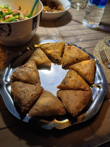 a plate of food on a table with a bowl of food at Dar HISANE in Marrakech