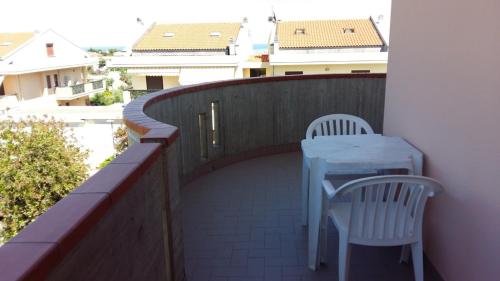 a table and two chairs on a balcony at B&B Mirella in Citta' Sant'Angelo