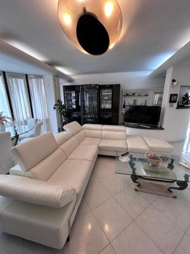 a living room with a white couch and a table at Villa Pina b&b in Colleferro
