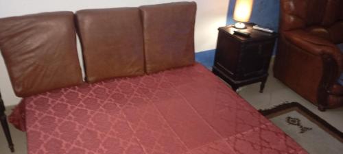 a bed with a leather seat in a room at VISIt CASTELO BRANCO in Castelo Branco