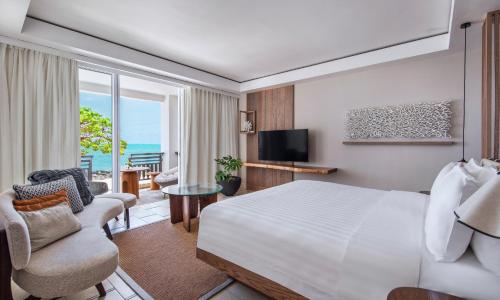 a hotel room with a bed and a balcony at Shangri-La Le Touessrok, Mauritius in Trou dʼ Eau Douce