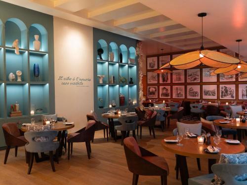 a restaurant with tables and chairs in a room at Fairmont Riyadh in Riyadh