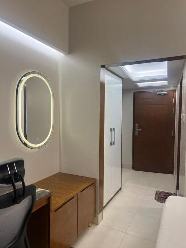 a bathroom with a sink and a mirror and a door at Hotel Kollol by J&Z Group in Cox's Bazar
