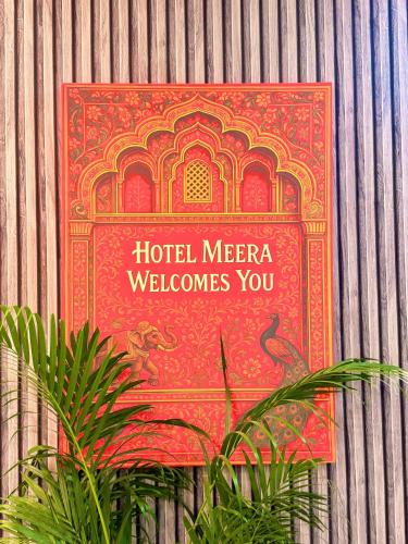 a sign on the wall of a hotel mecca welcomes you at Hotel Meera in Bāwal