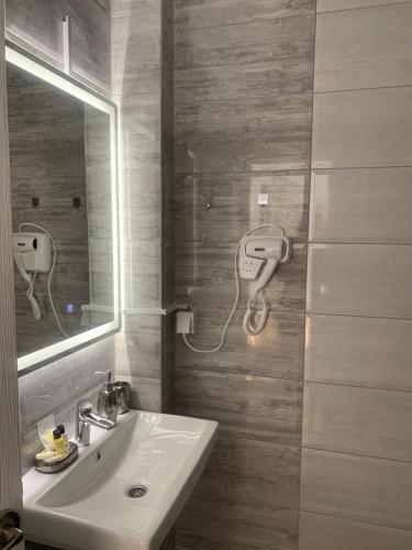 a bathroom with a sink and a mirror at Apartment Aluna 4 in Višegrad